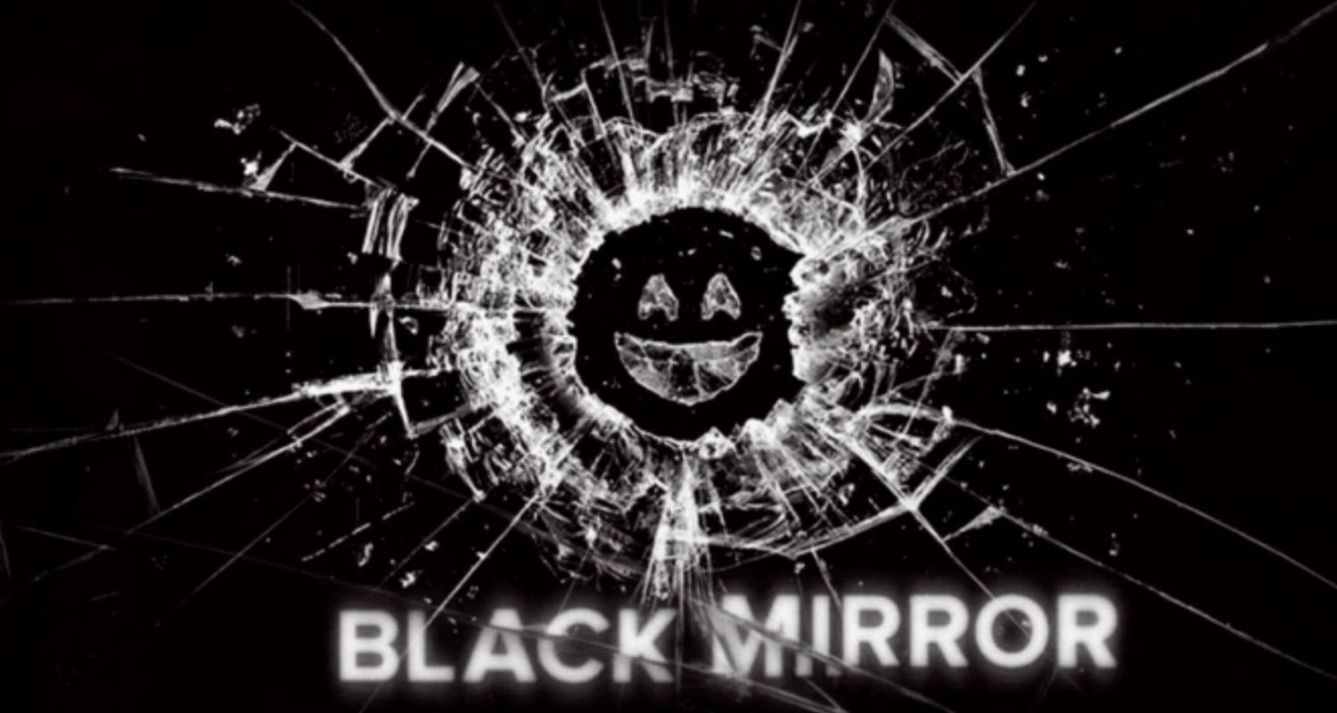 Cracked glass with a smiling face in the center, surrounded by radiating lines. The words "Black Mirror" in bold white text appear at the bottom.